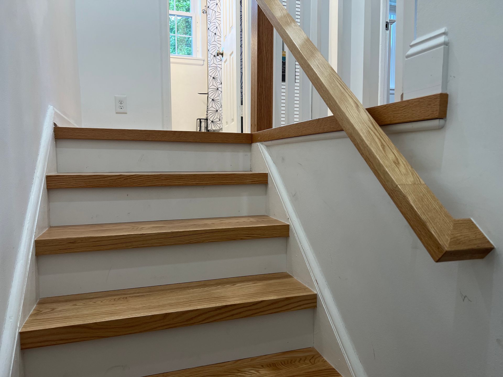 A staircase with wooden steps and a wooden railing