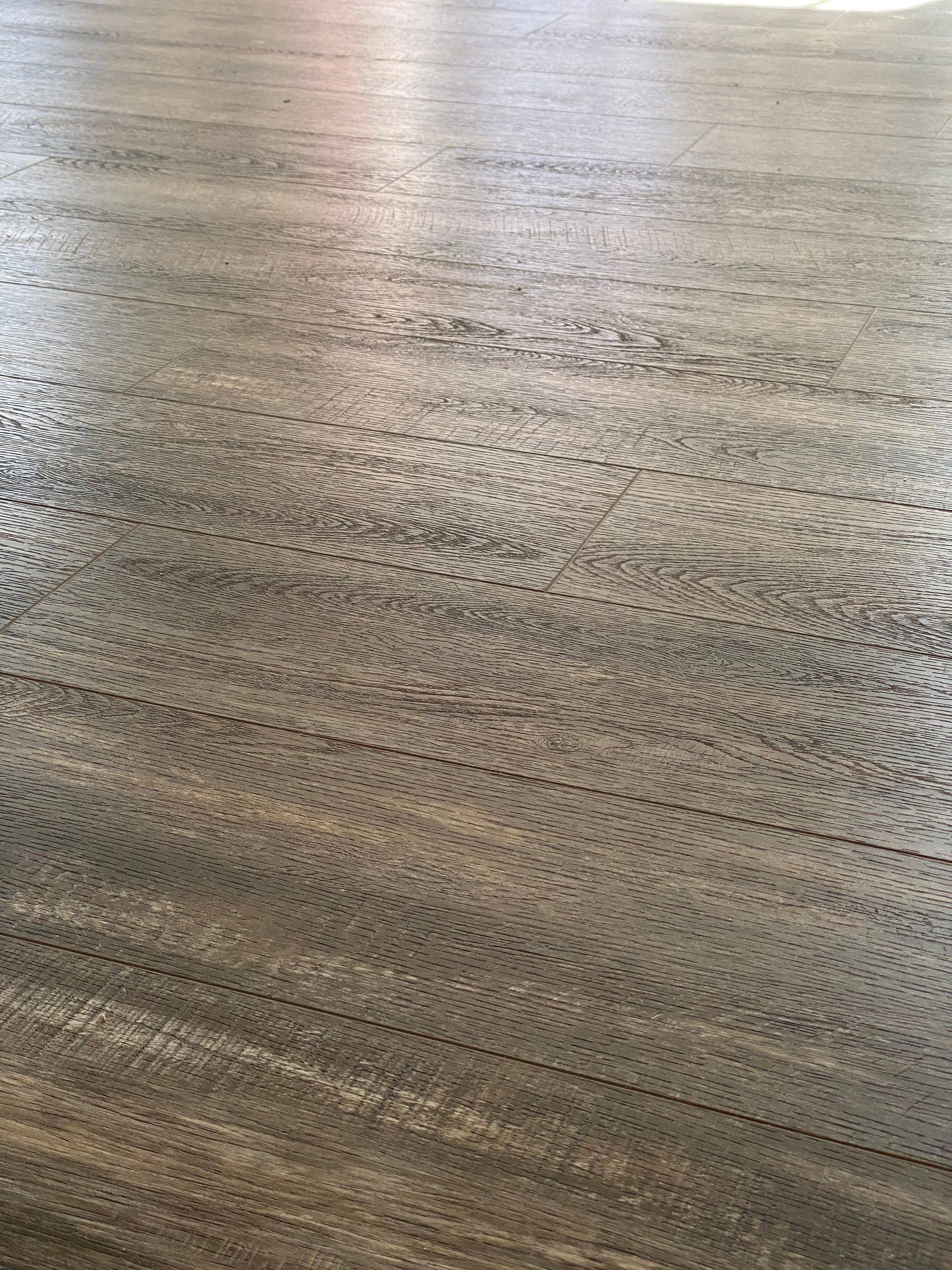 A close up of a concrete floor with a lot of small holes in it.