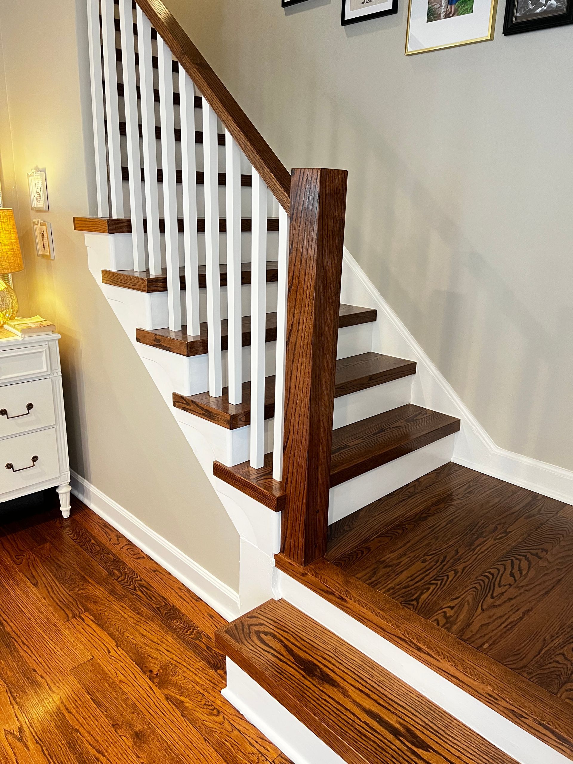 A wooden staircase with white railings and wooden steps