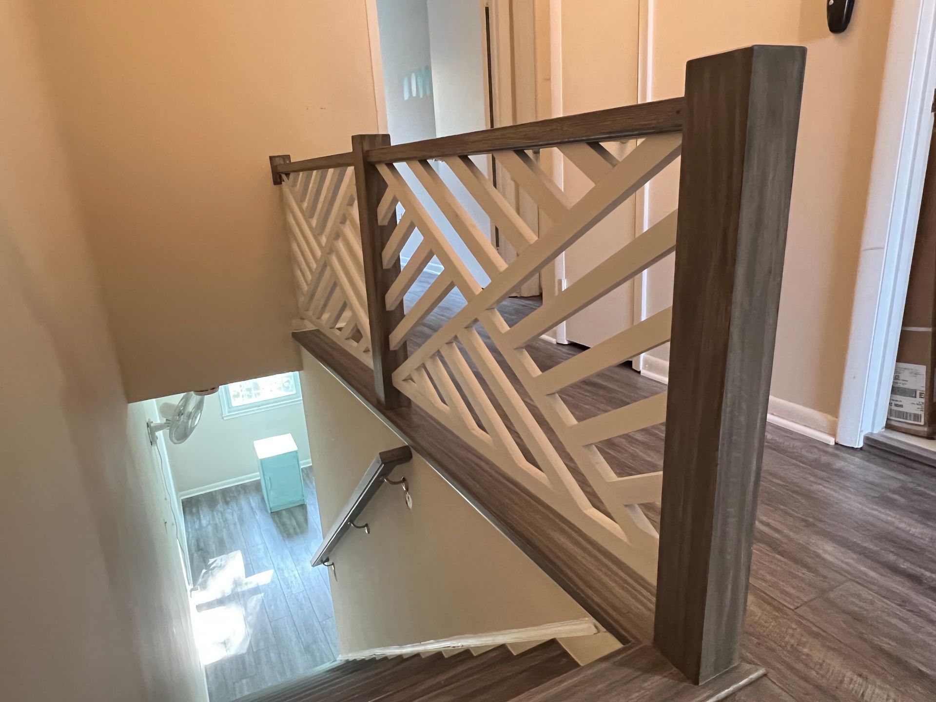 A wooden railing on a set of stairs in a house.