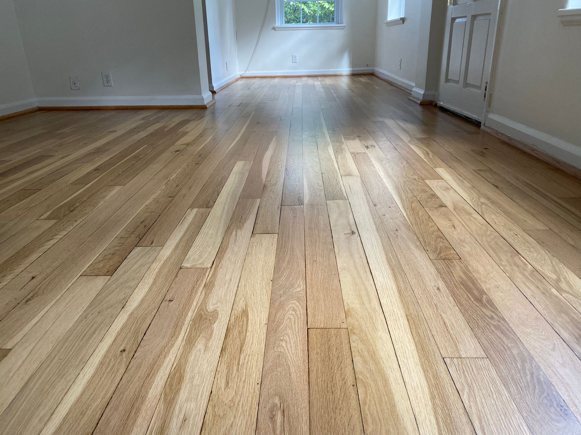 A room with a wooden floor and white walls.