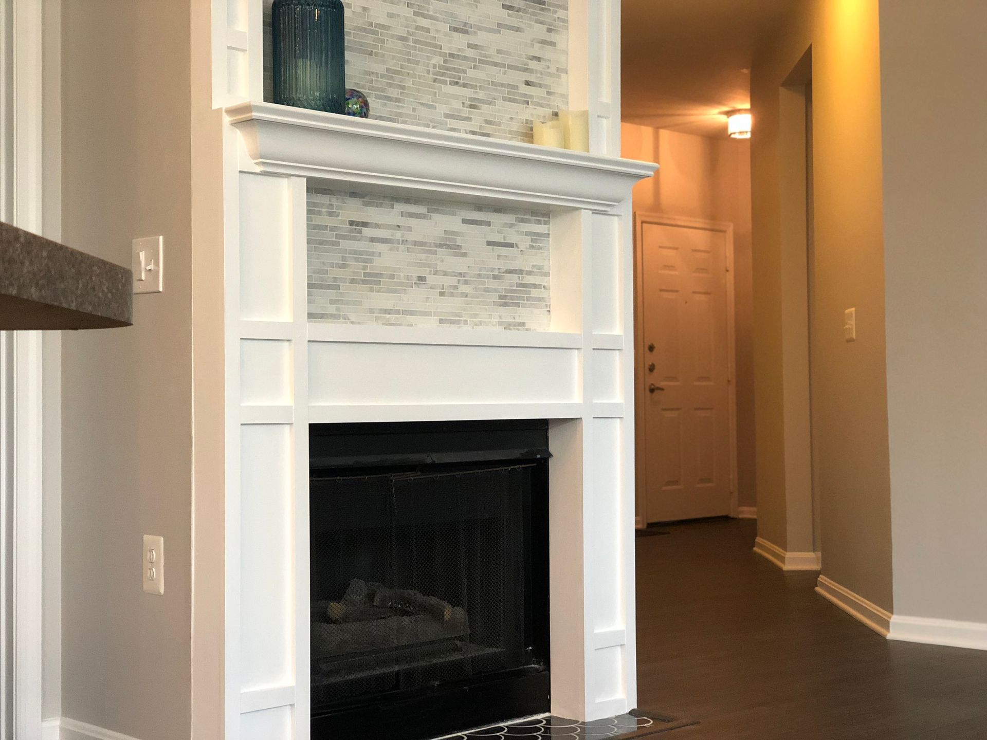 A living room with a fireplace and a mantle