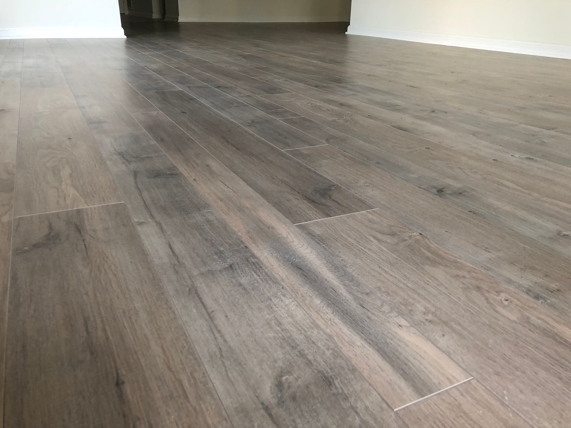 A close up of a wooden floor in an empty room.