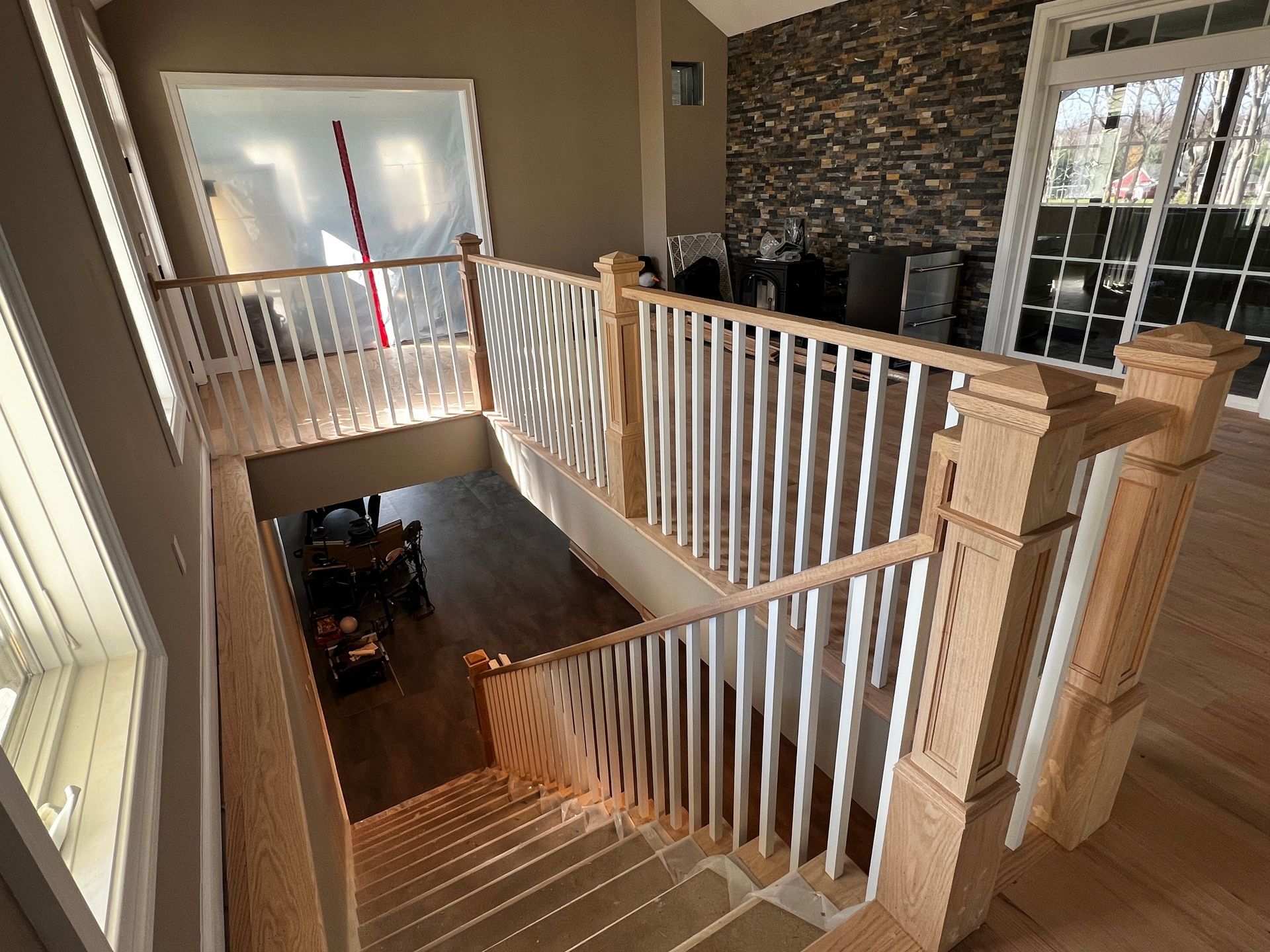 A wooden staircase with a white railing in a house