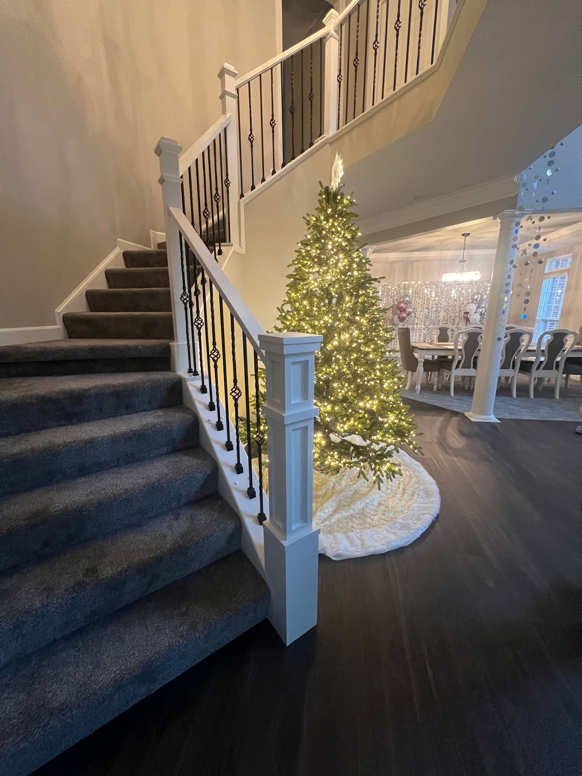 A staircase with a christmas tree in the middle of it.