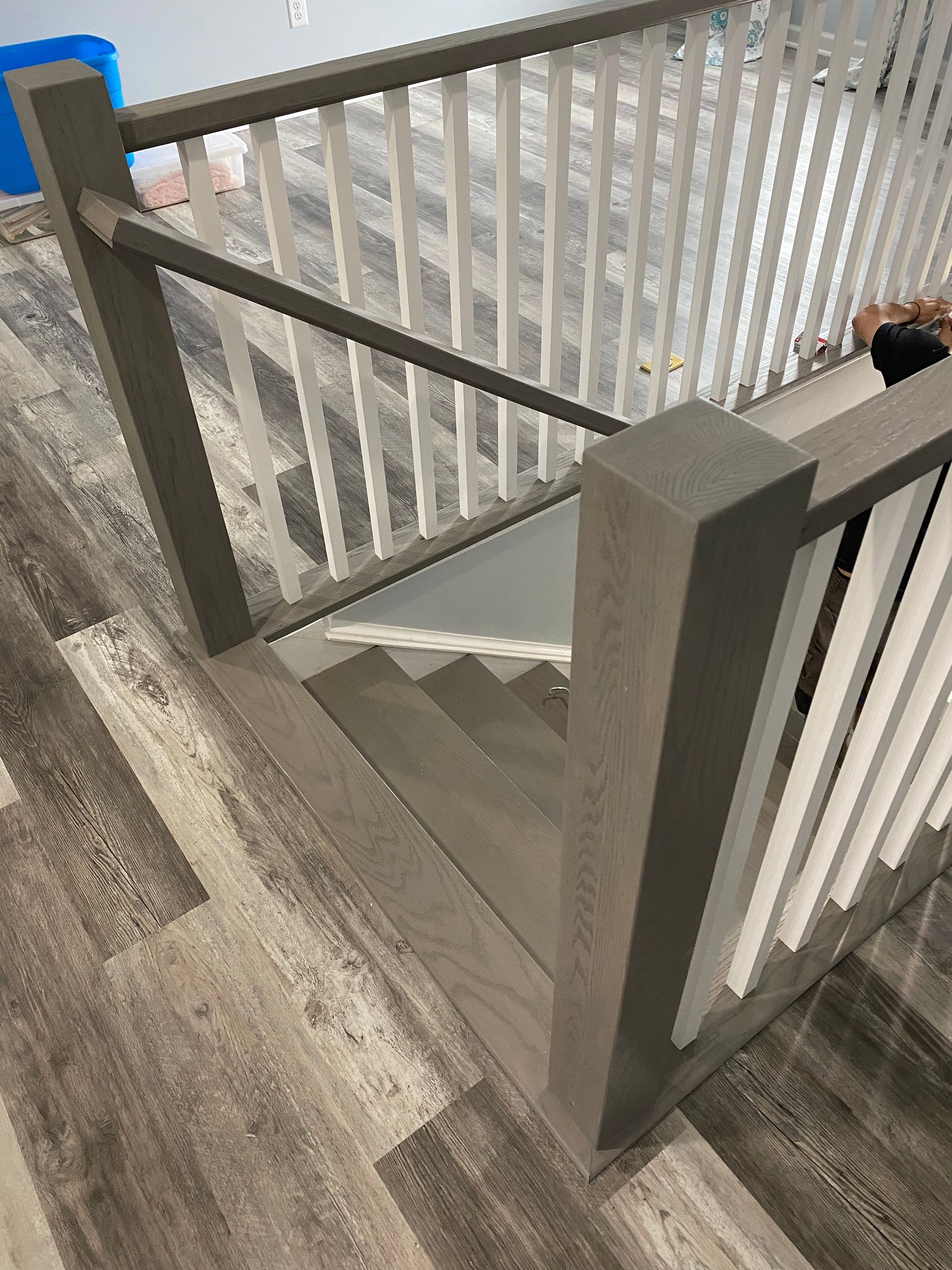 A staircase with a wooden railing and a glass railing.