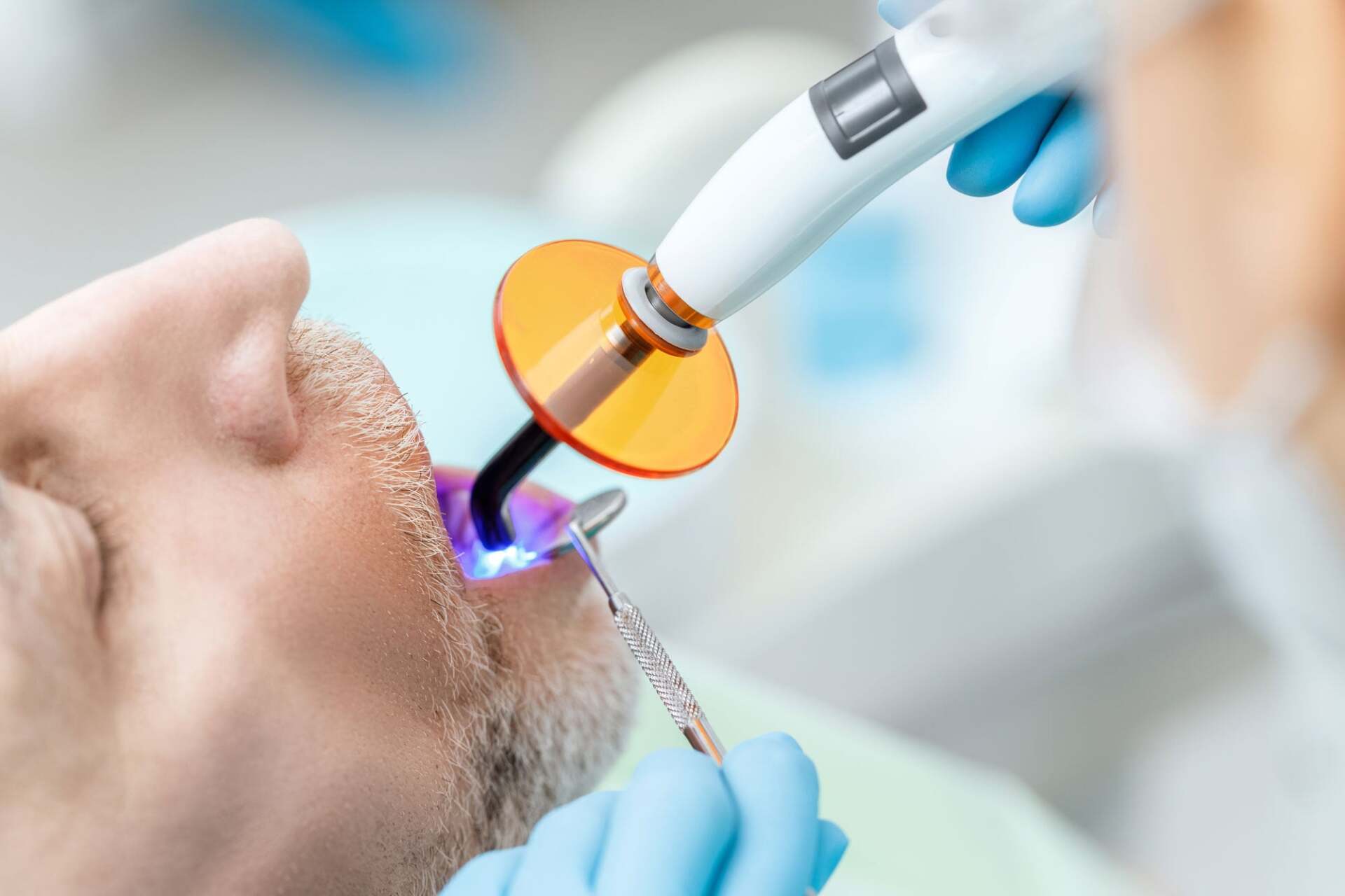 man getting his teeth checked at dentist