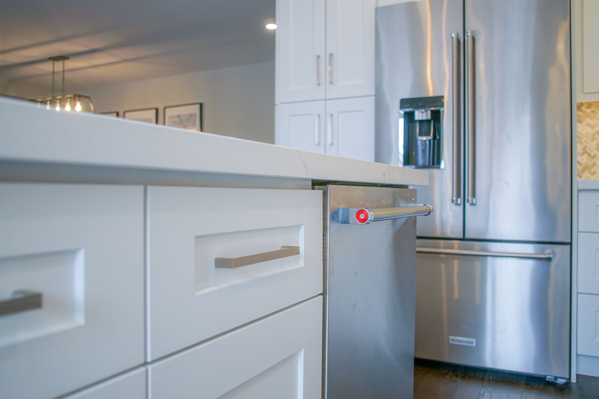 A kitchen with stainless steel appliances and white cabinets.