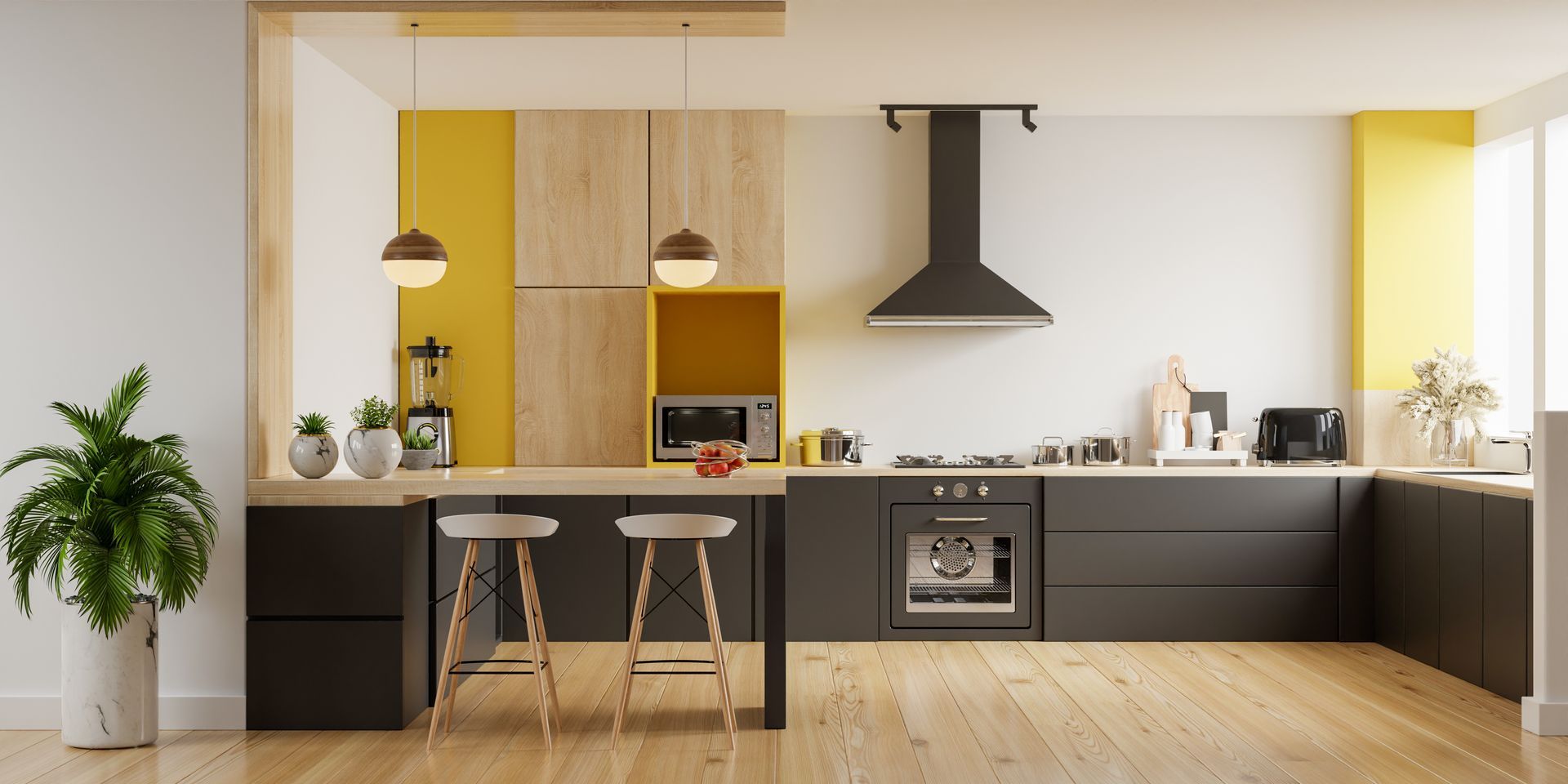 A modern kitchen with black cabinets , wooden floors , and yellow walls.