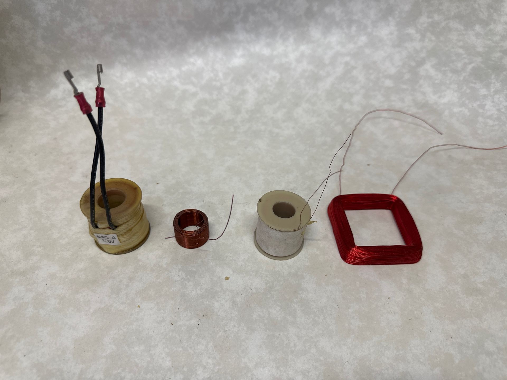 Coils of wire in various sizes and shapes on a light surface