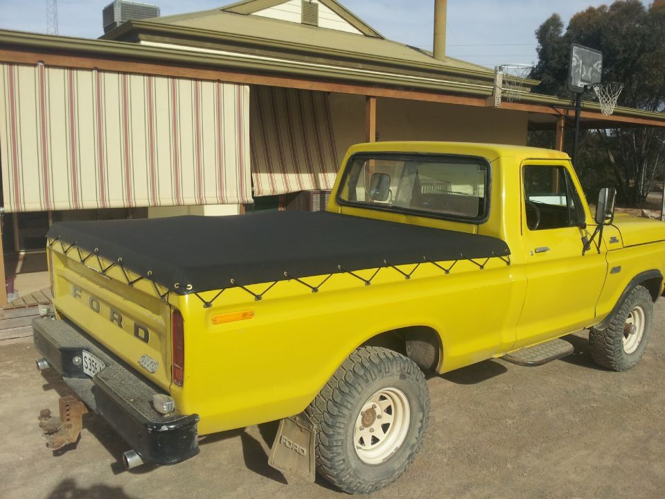 newly installed black canvas cover at the rear of the car
