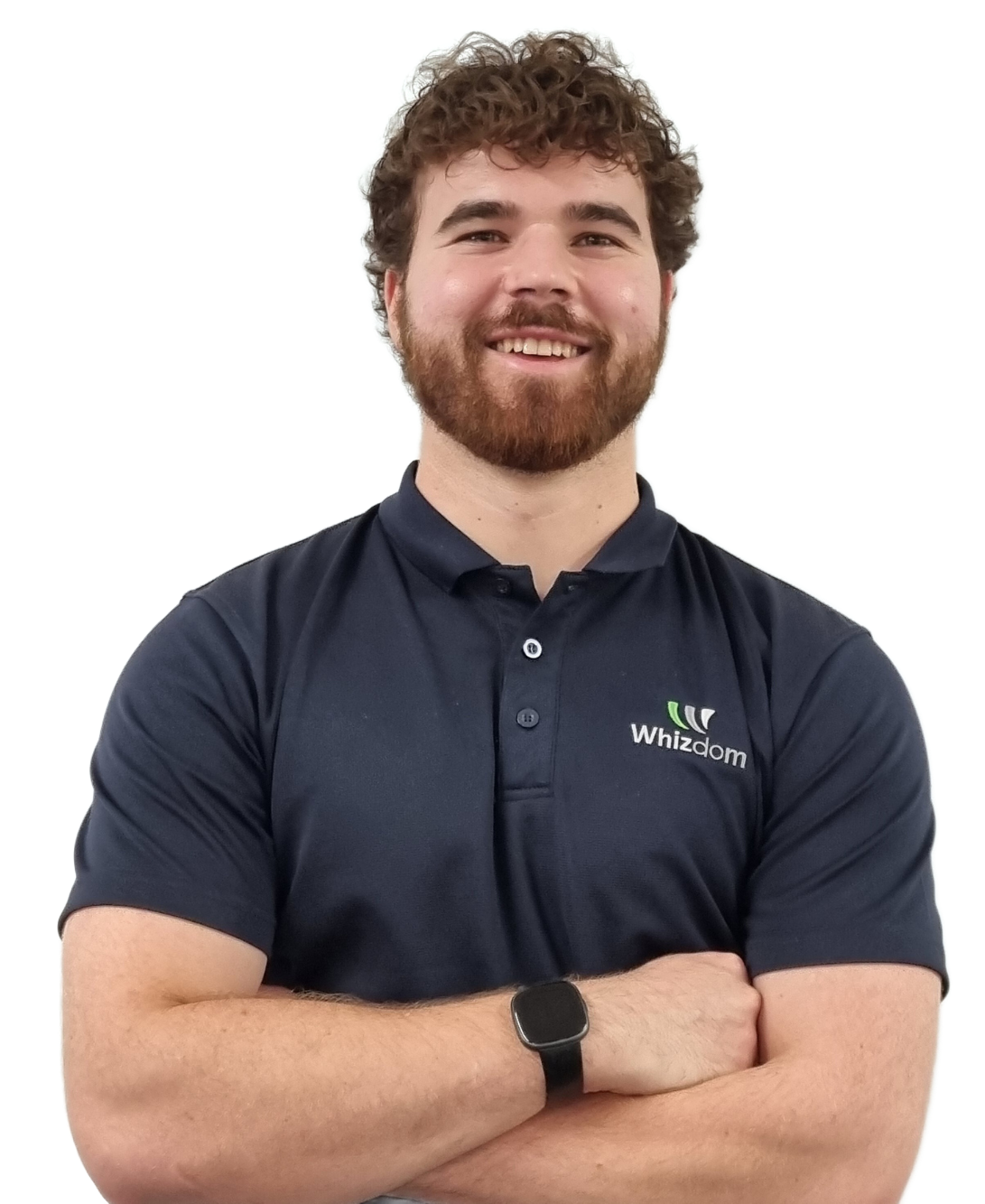 Man with curly hair and beard wearing a navy polo shirt, arms crossed, smiling at the camera.