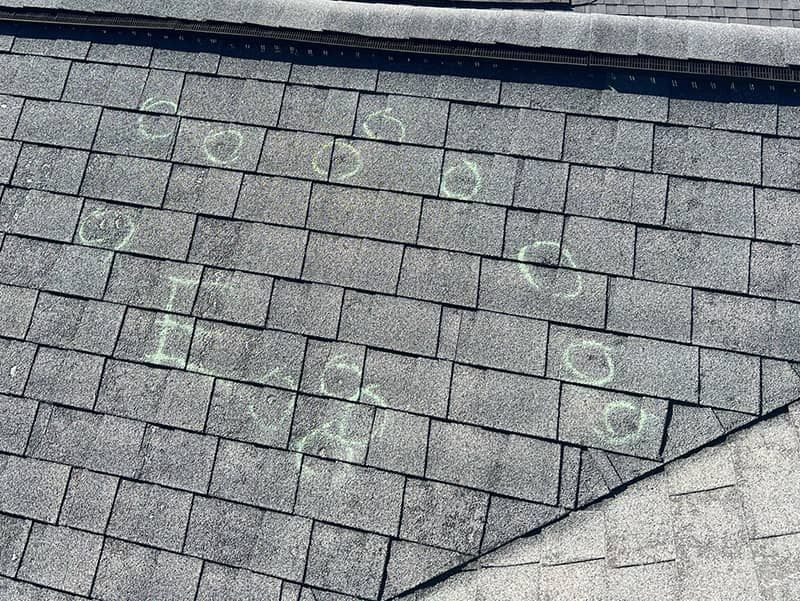 A close up of a roof with hail damage on it.