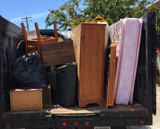 Dumpster with Furniture Junk