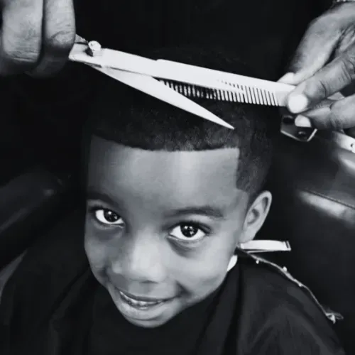 Barber cutting a child's hair in at The Fade Brothers - Indianapolis, IN