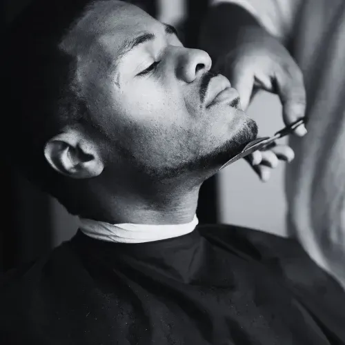 Person getting beard trimmed with scissors at The Fade Brothers - Indianapolis, IN