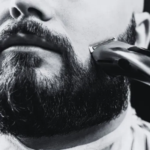 Close-up of a beard being trimmed with an electric razor at The Fade Brothers - Indianapolis, IN