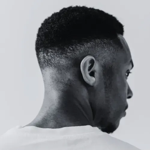 Man with faded haircut, facing right, looking down at The Fade Brothers - Indianapolis, IN