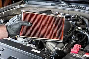 Removing a dirty automotive air filter — Full service auto repair shop in Bellingham, WA
