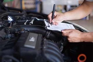 Mechanic repairman inspecting car — Full service auto repair shop in Bellingham, WA