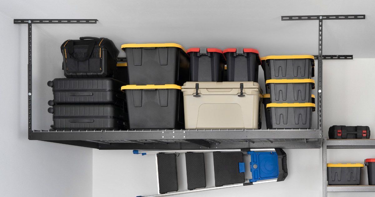 Overhead garage storage rack holding totes, toolboxes, and a cooler. A ladder is stored below.
