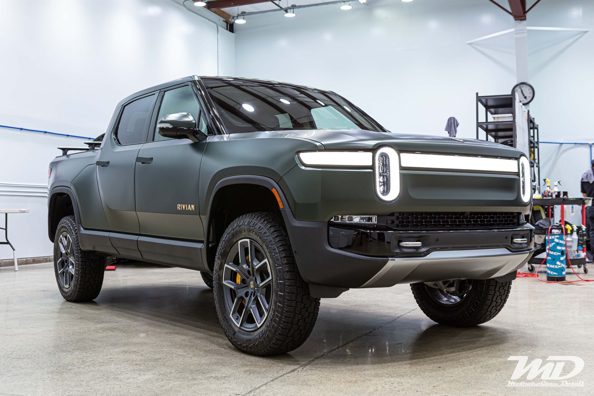 A black pickup truck is parked in a garage.