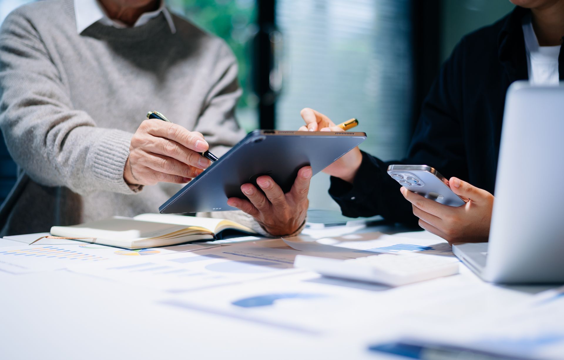 A man in a suit is typing on a laptop computer.