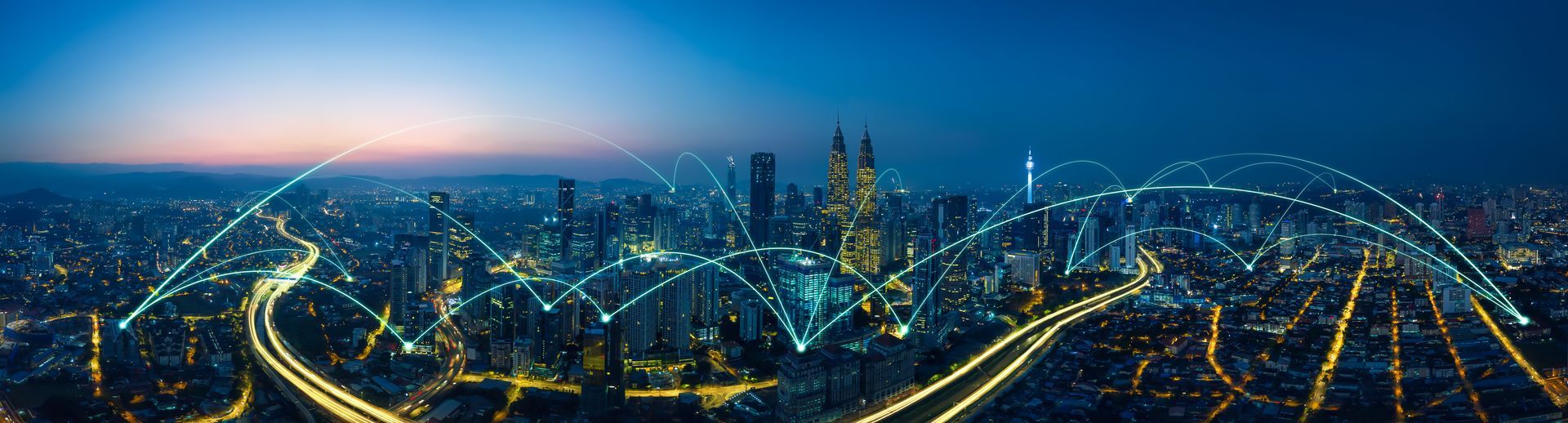 A man in a suit is typing on a laptop computer.