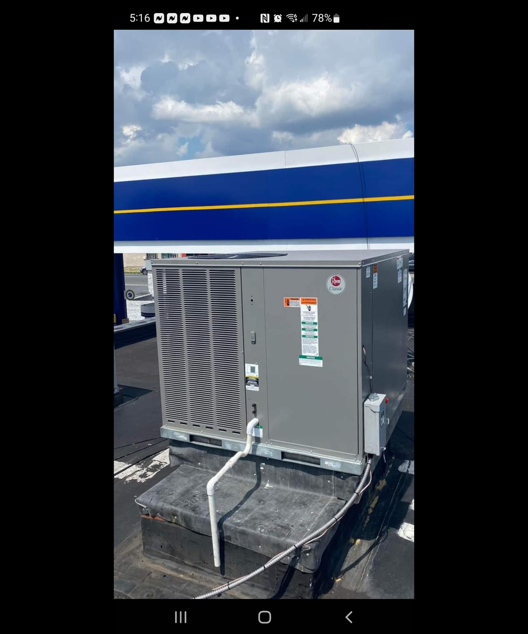 A picture of an air conditioner on top of a building.