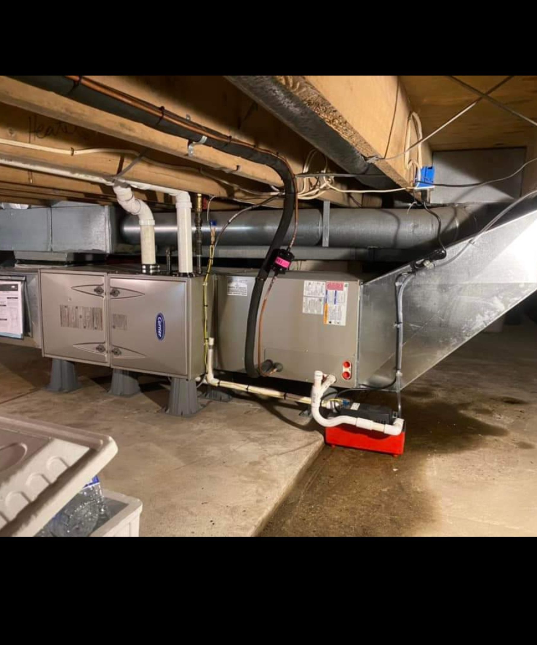 There is a red cooler in the corner of the room.