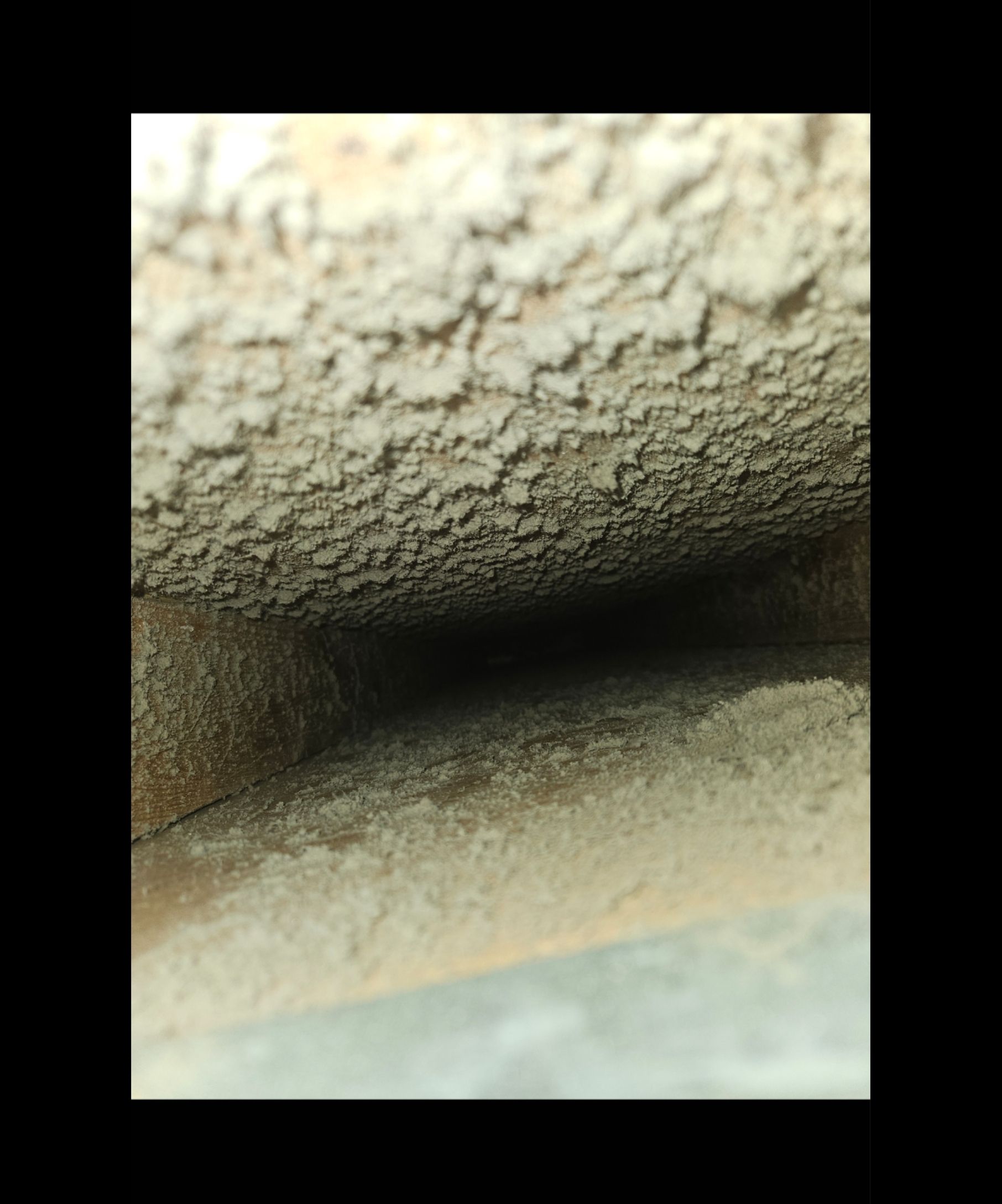 A close up of a concrete wall with a hole in it.