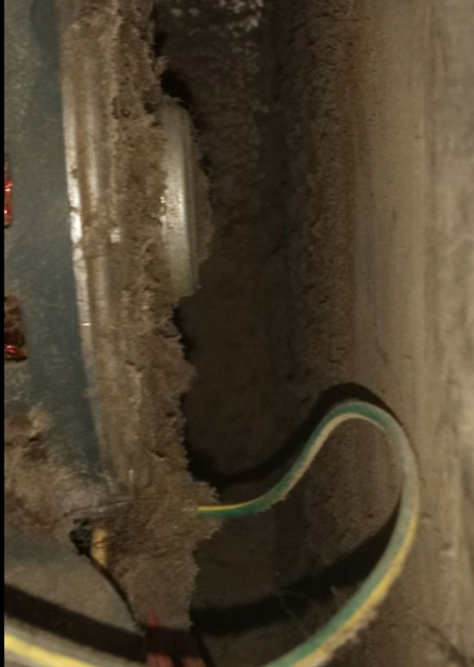 A close up of a hose connected to a wall.