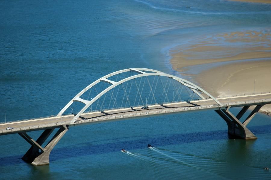 an aerial view of a bridge over a body of water