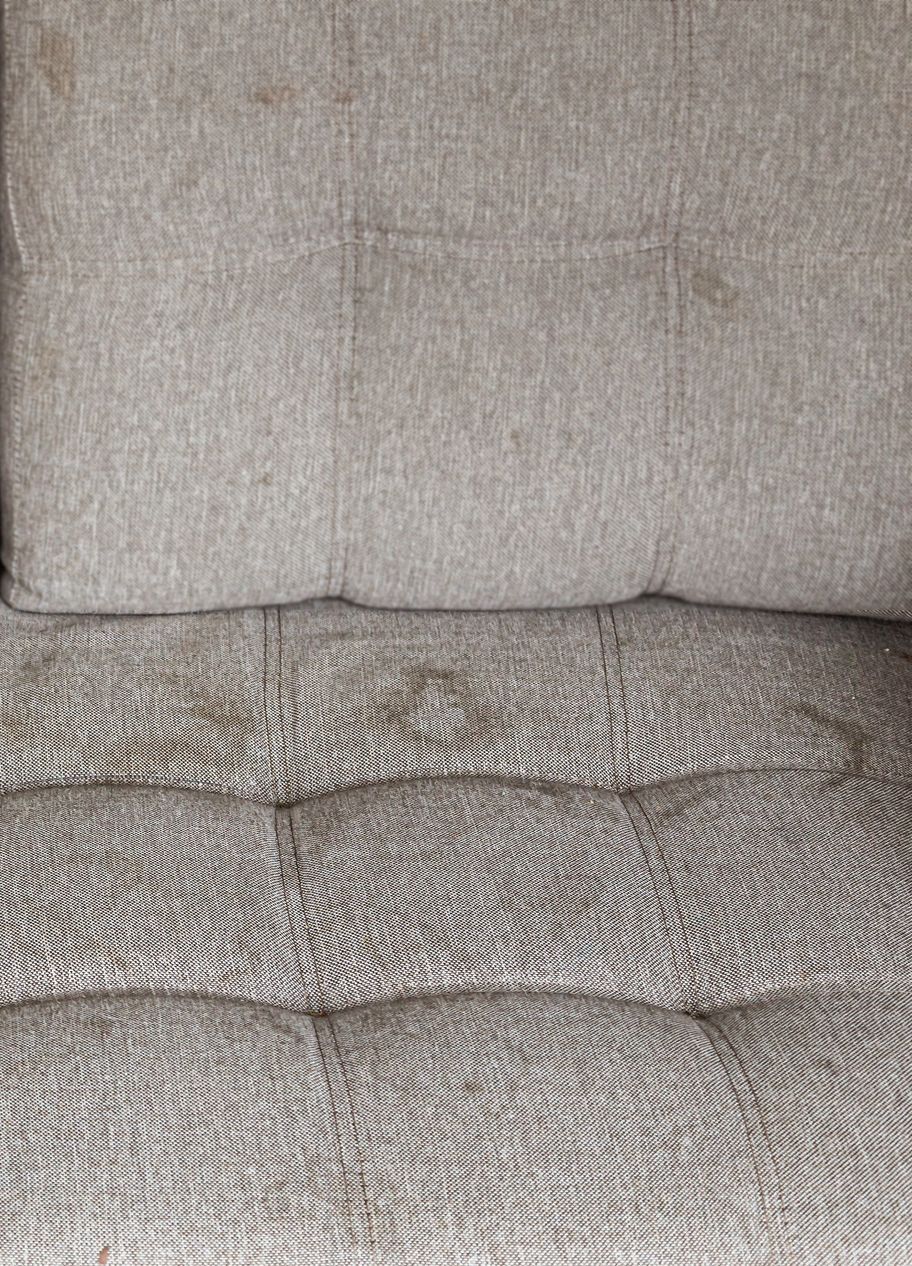 A close up of a couch with two pillows on it.