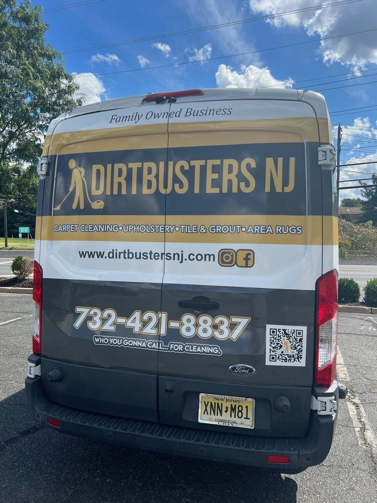 A dirtbusters nj van is parked in a parking lot.