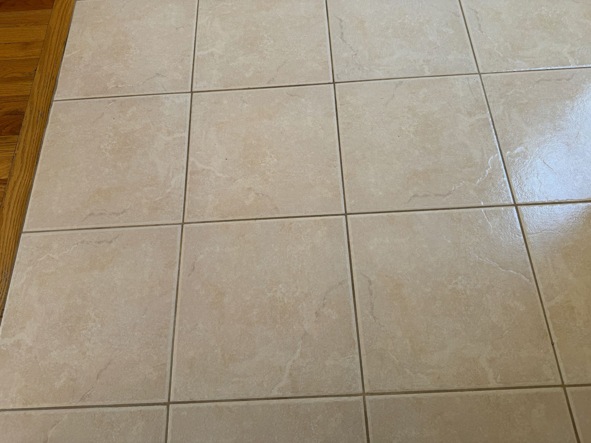 A close up of a gray tile floor with white grout.