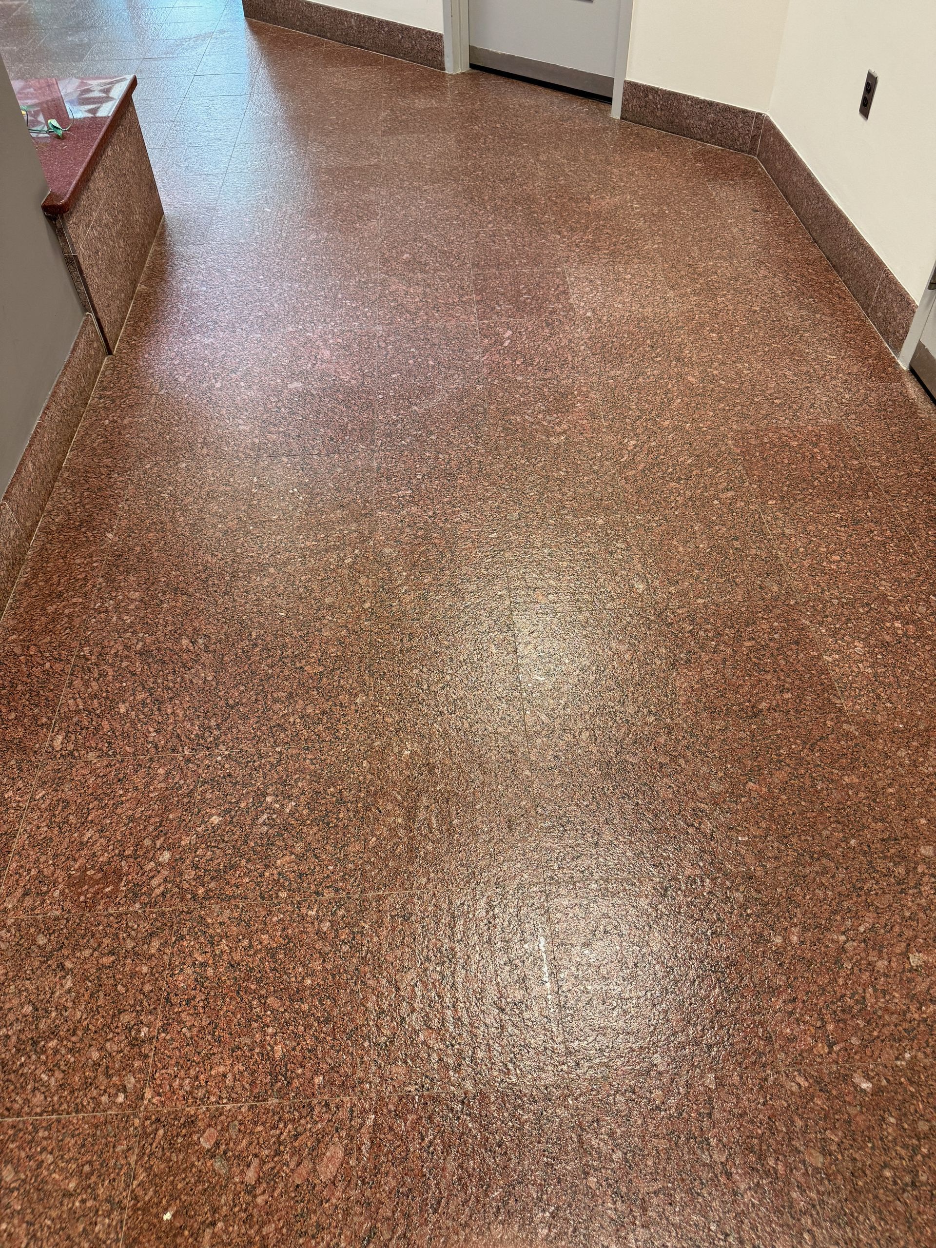 A close up of a brown floor in a room.