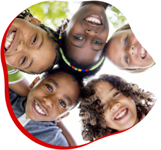 Five smiling children leaning in a circle, looking down at the camera against a bright background