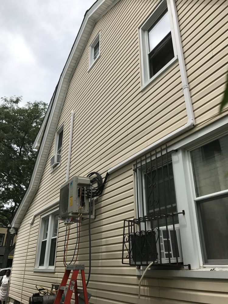 a ladder is sitting on the side of a house next to a window .
