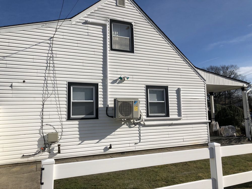 a white house with a white fence in front of it .
