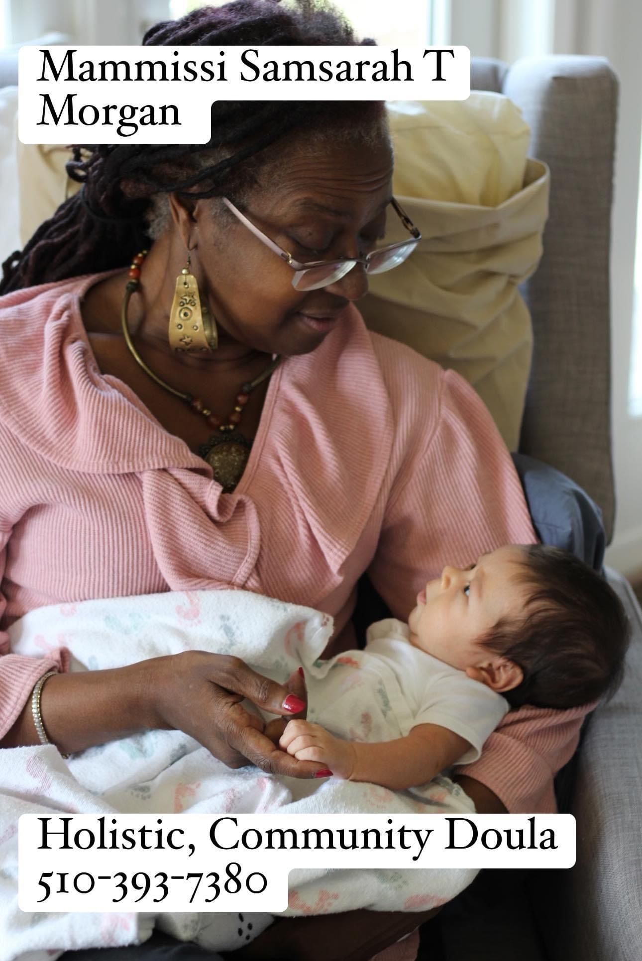 Woman is Holding a Baby in her Arms