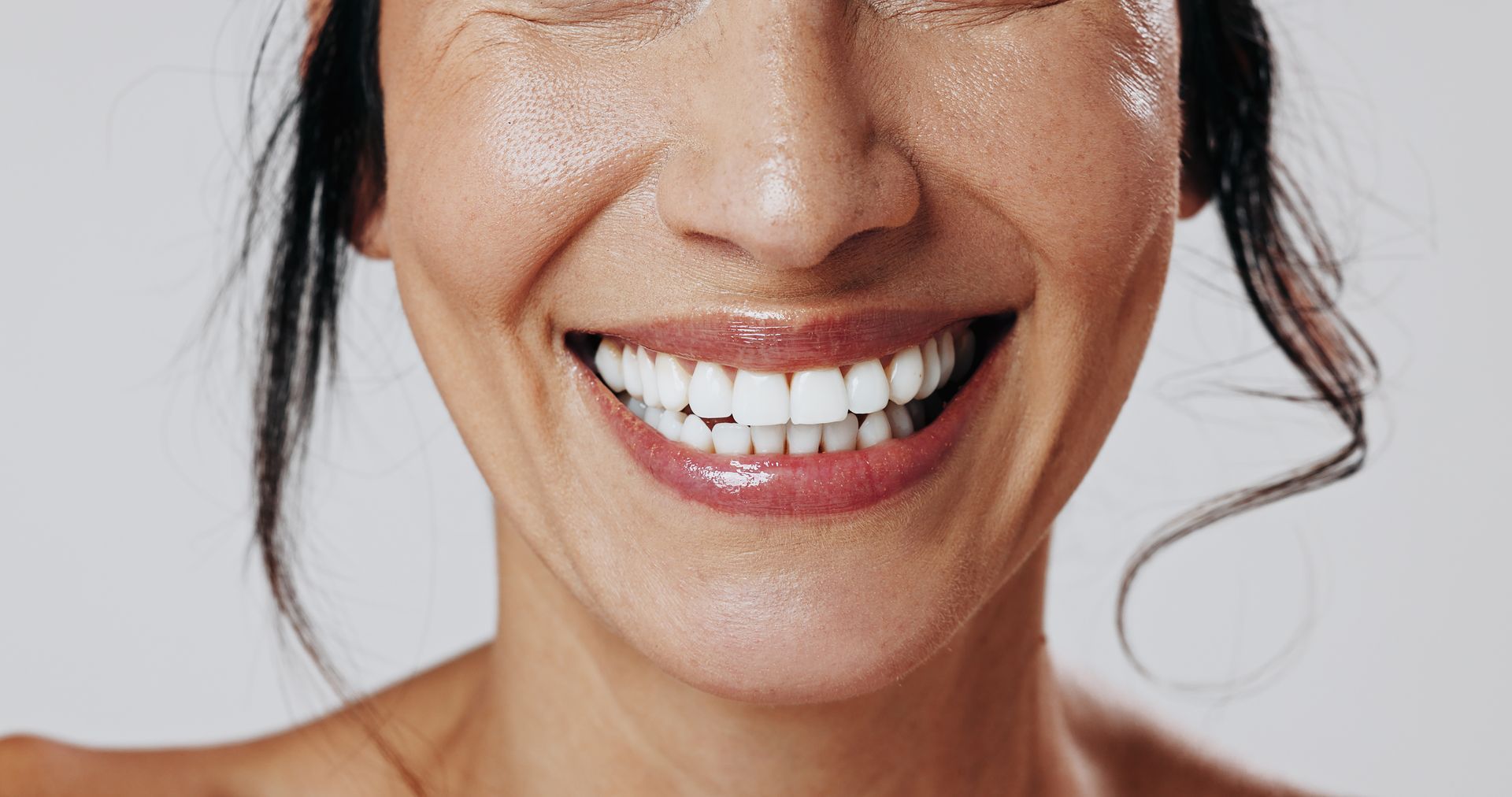 Close-up of a person holding a silicone tray for a DIY teeth whitening treatment. Close-up of a person holding a silicone tray for a DIY teeth whitening treatment.