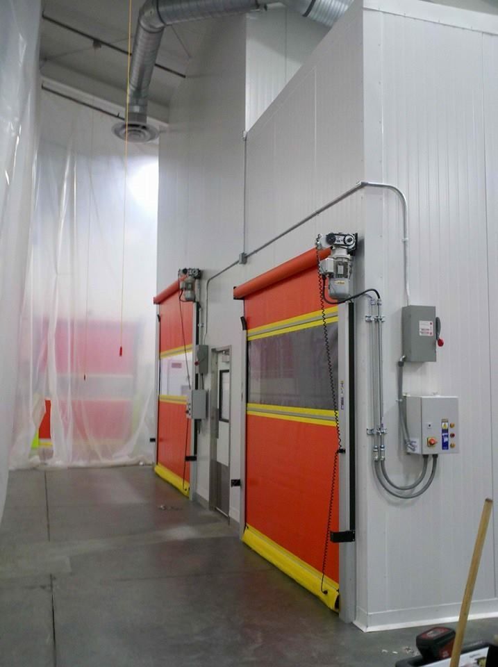 A room with red and yellow doors and a mop