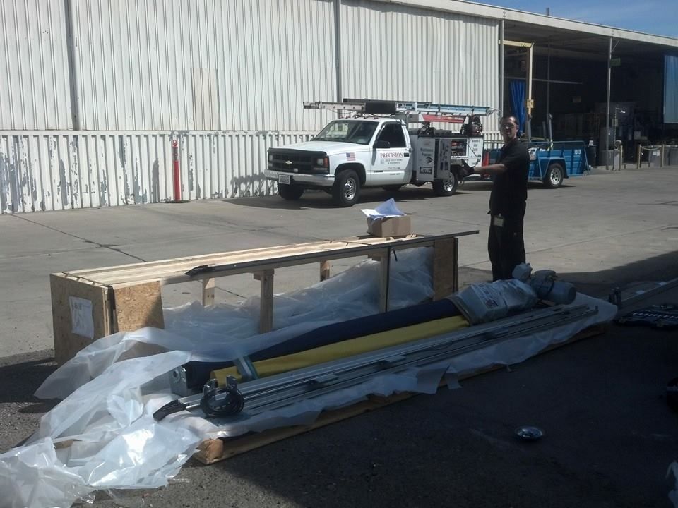 A white truck with the word fuel on the side is parked in front of a building