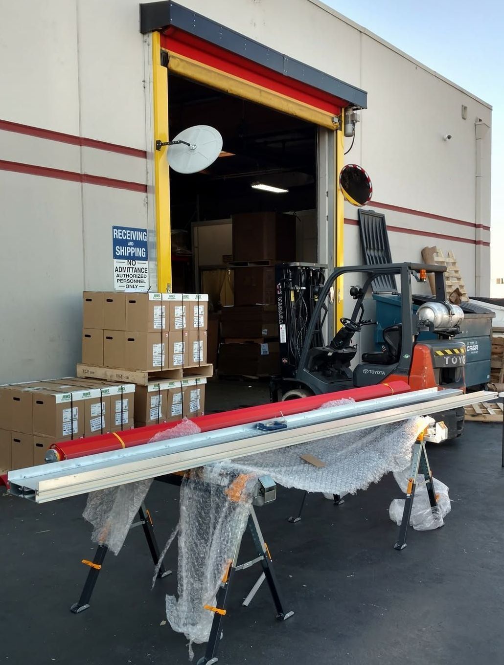 A forklift is parked in front of a building