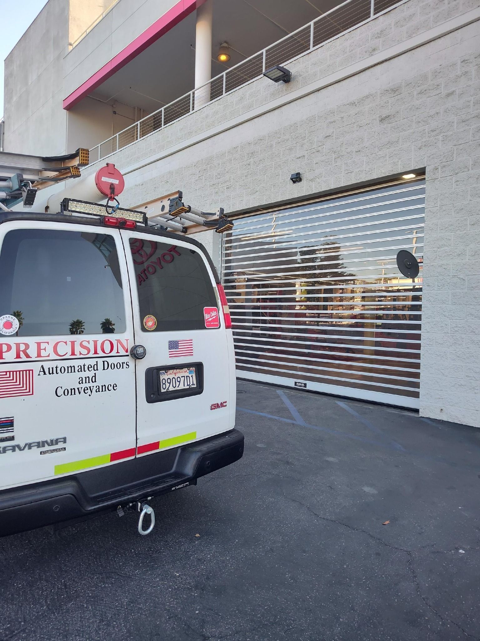 A man is standing next to a large pipe in a garage.