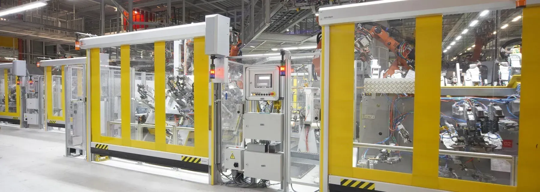 A row of yellow sliding doors in a factory.