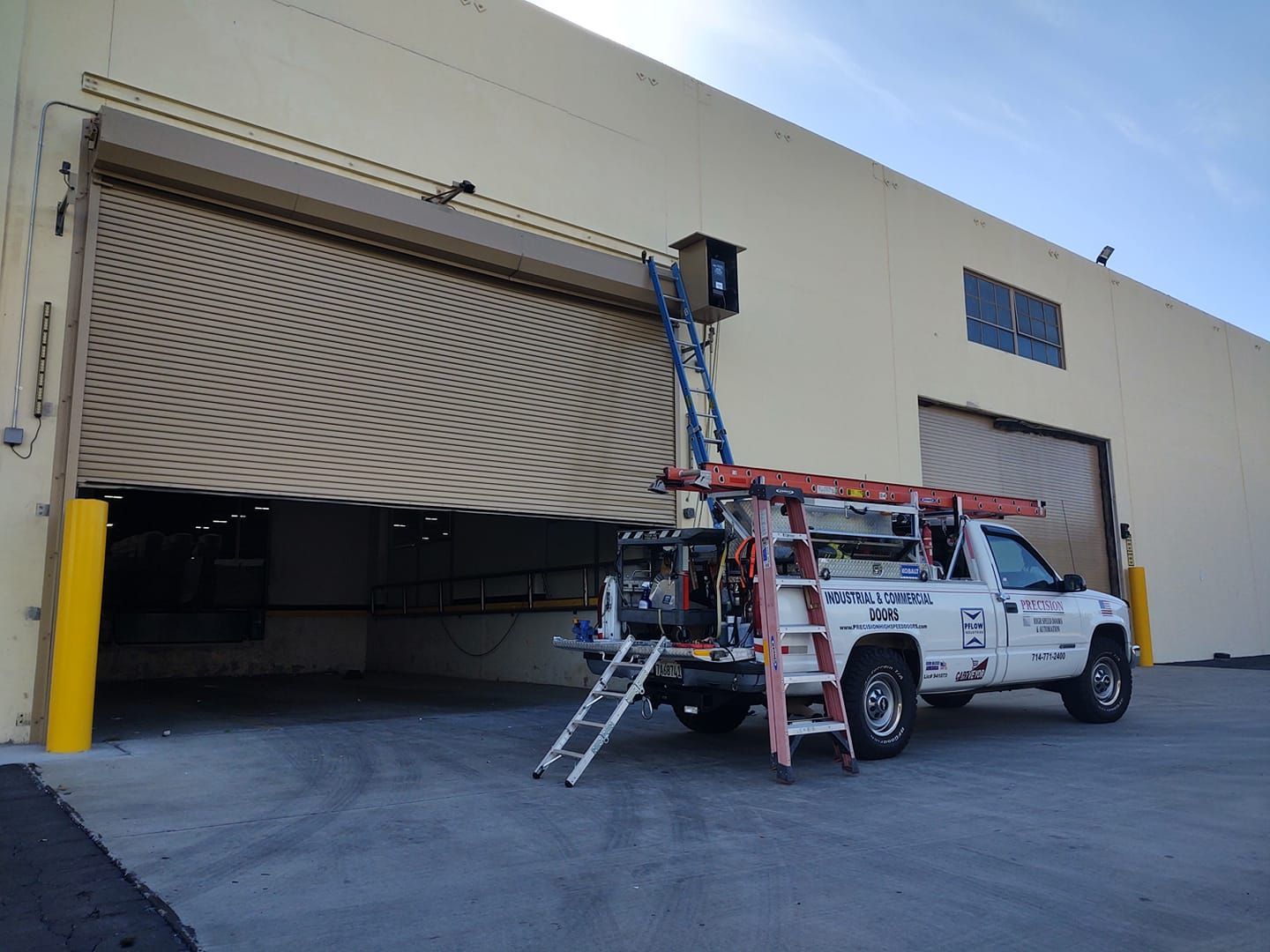 A warehouse with a yellow door that is open