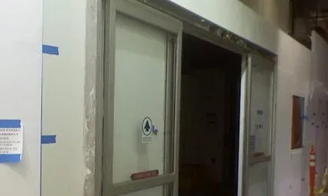 A sliding glass door is being installed in a building.