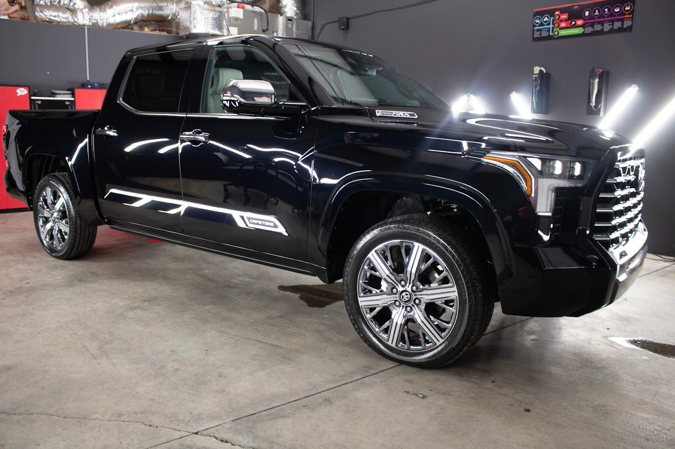 Mirror-like reflection on a black Tundra after professional paint correction and Owner’s Pride coating.